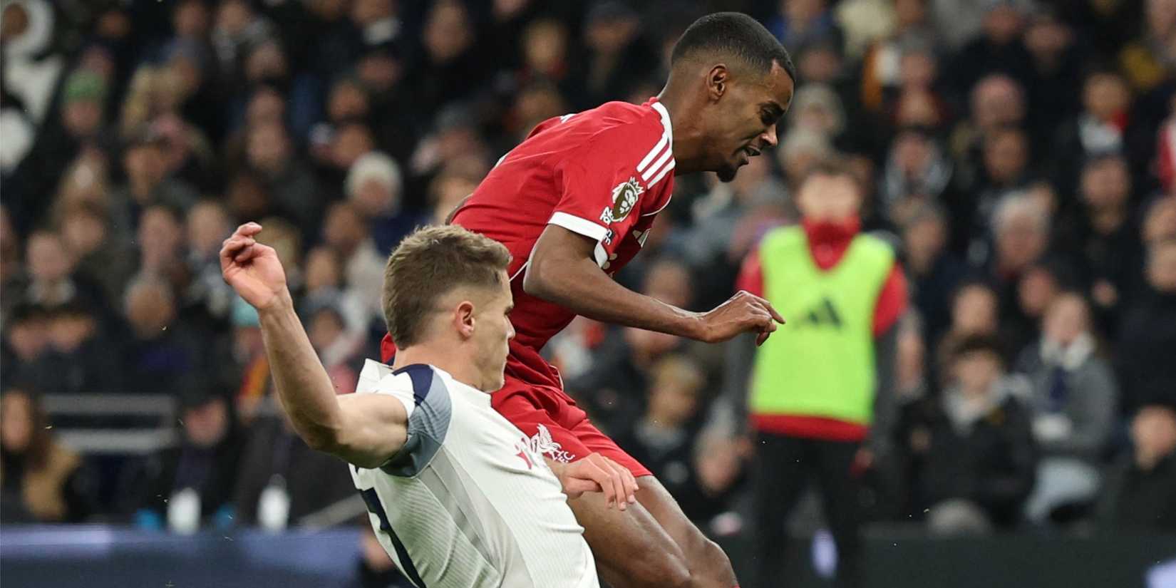 Liverpool's Alexander Isak scores despite a sliding tackle from Tottenham's Micky Van de Ven.