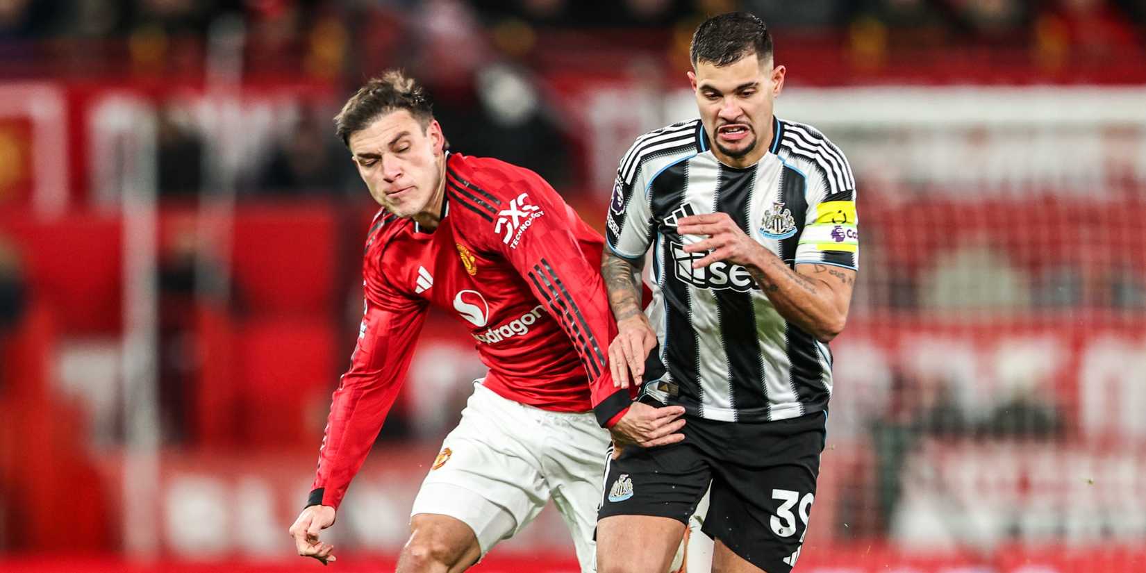 Manuel Ugarte of Manchester Untied tries to tackle Bruno Guimaraes of Newcastle United