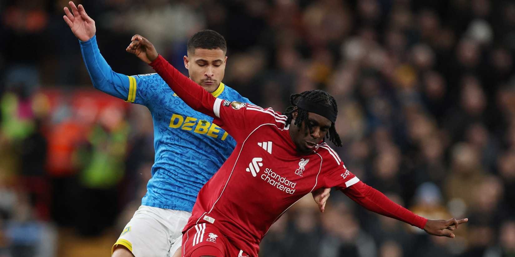 Liverpool's Jeremie Frimpong in action with Wolverhampton Wanderers' Joao Gomes