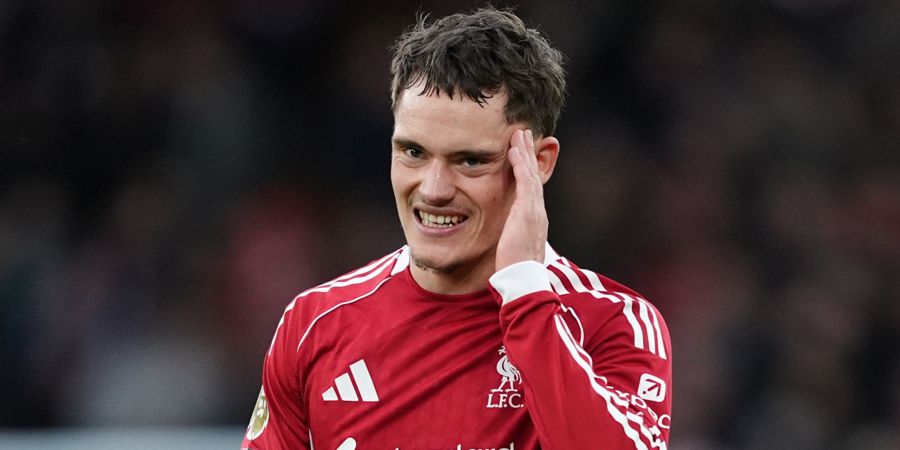 Liverpool's Florian Wirtz rubs his head.