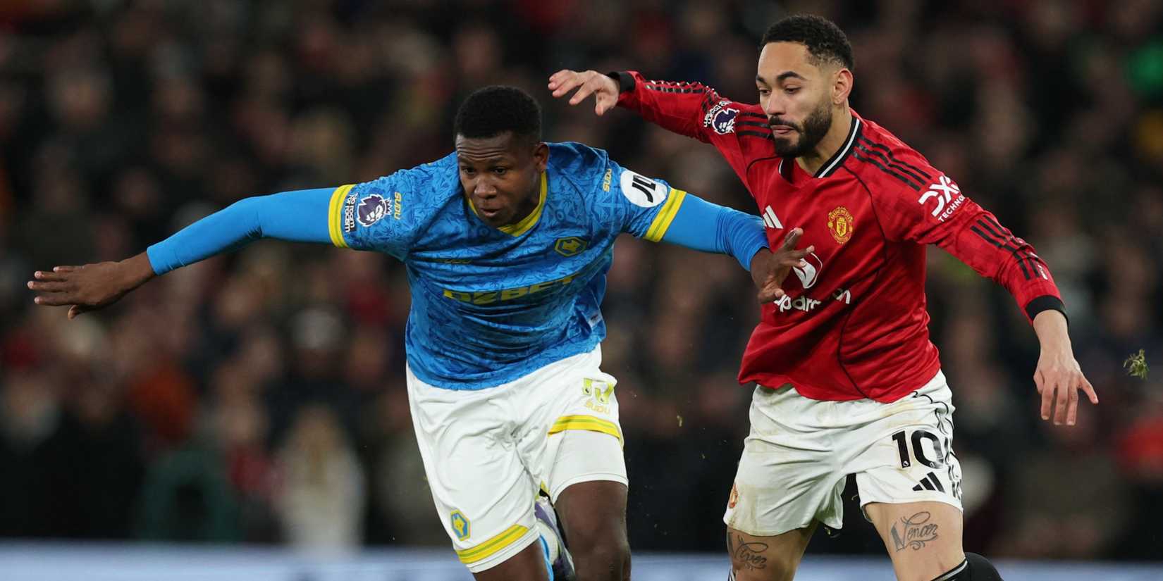 Manchester United's Matheus Cunha in action with Wolverhampton Wanderers' Yerson Mosquera