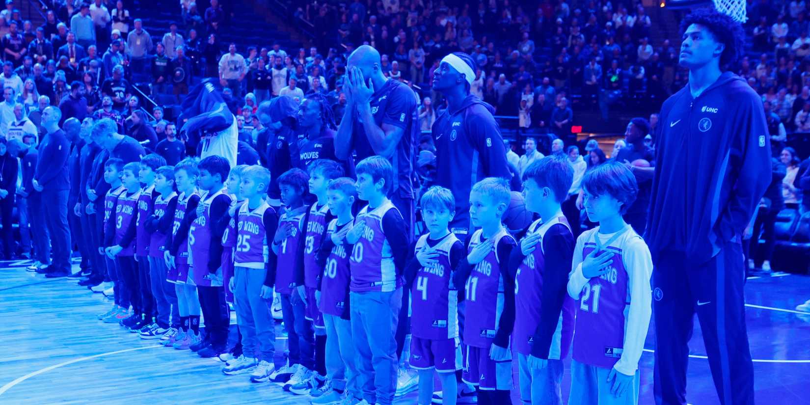 The Minnesota Timberwolves players line up with a youth team and honor Renee Good with a moment of silence before the game with the Cleveland Cavaliers at Target Center. 