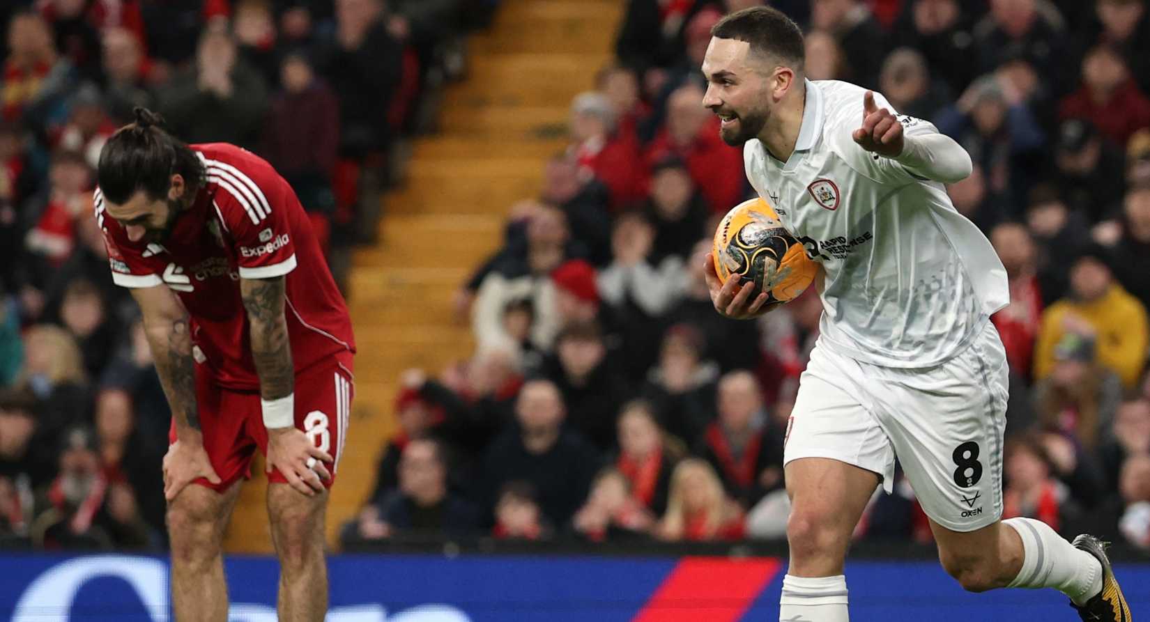 Barnsley's Adam Phillips celebrates scoring their first goal as Liverpool's Dominik Szoboszlai looks dejected