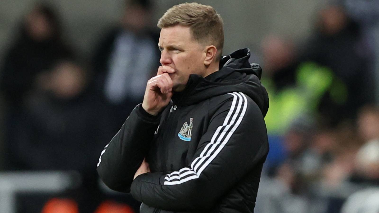 Newcastle United manager Eddie Howe puts his hand to his face.