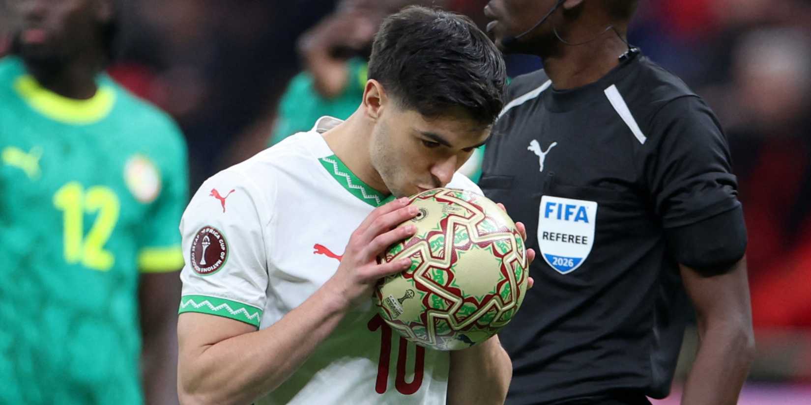 Morocco's Brahim Diaz kisses the ball as he prepares to take a penalty vs Senegal