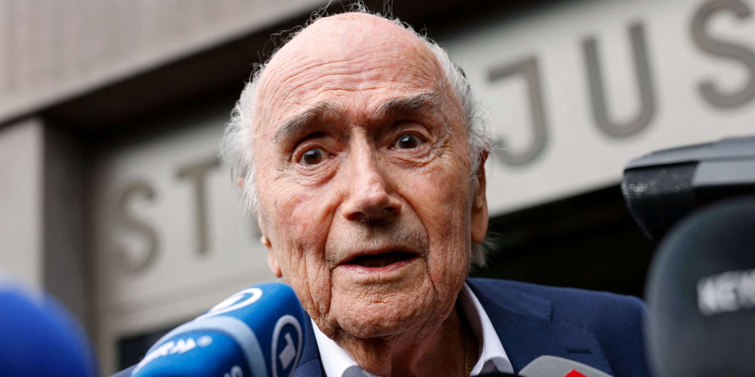 Former FIFA President Sepp Blatter speaks with members of the media as he leaves the tribunal after getting acquitted off corruption charges against him in Muttenz, Switzerland