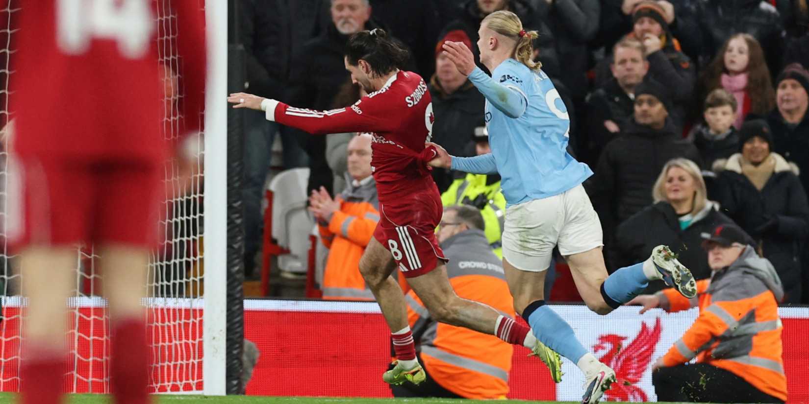 Liverpool's Dominik Szoboszlai is challenged by Manchester City's Erling Haaland as Rayan Cherki scores a goal which is later disallowed before Szoboszlai is sent off upon VAR review for an earlier offence