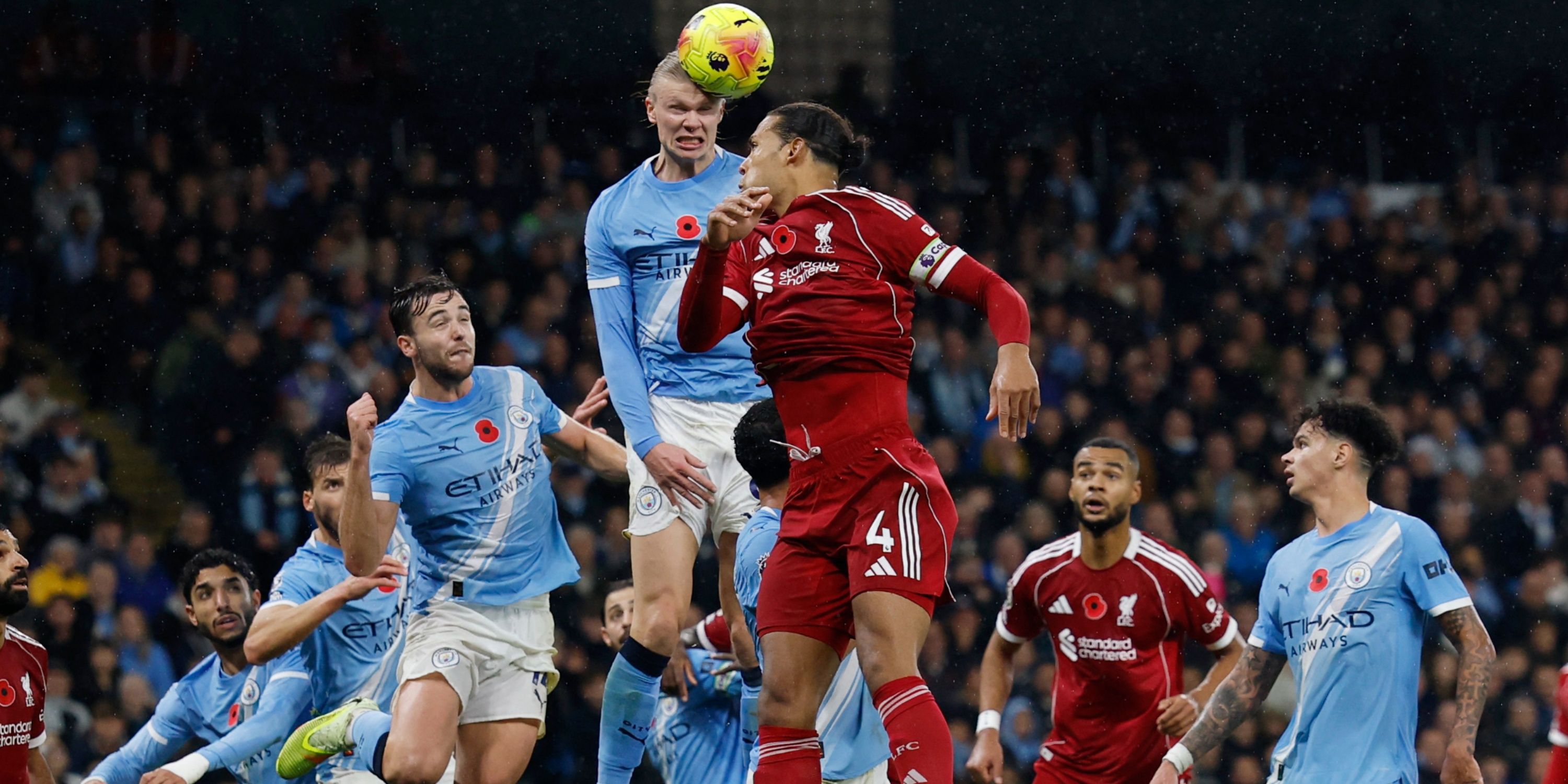 Erling Haaland and Virgil van Dijk compete for a header