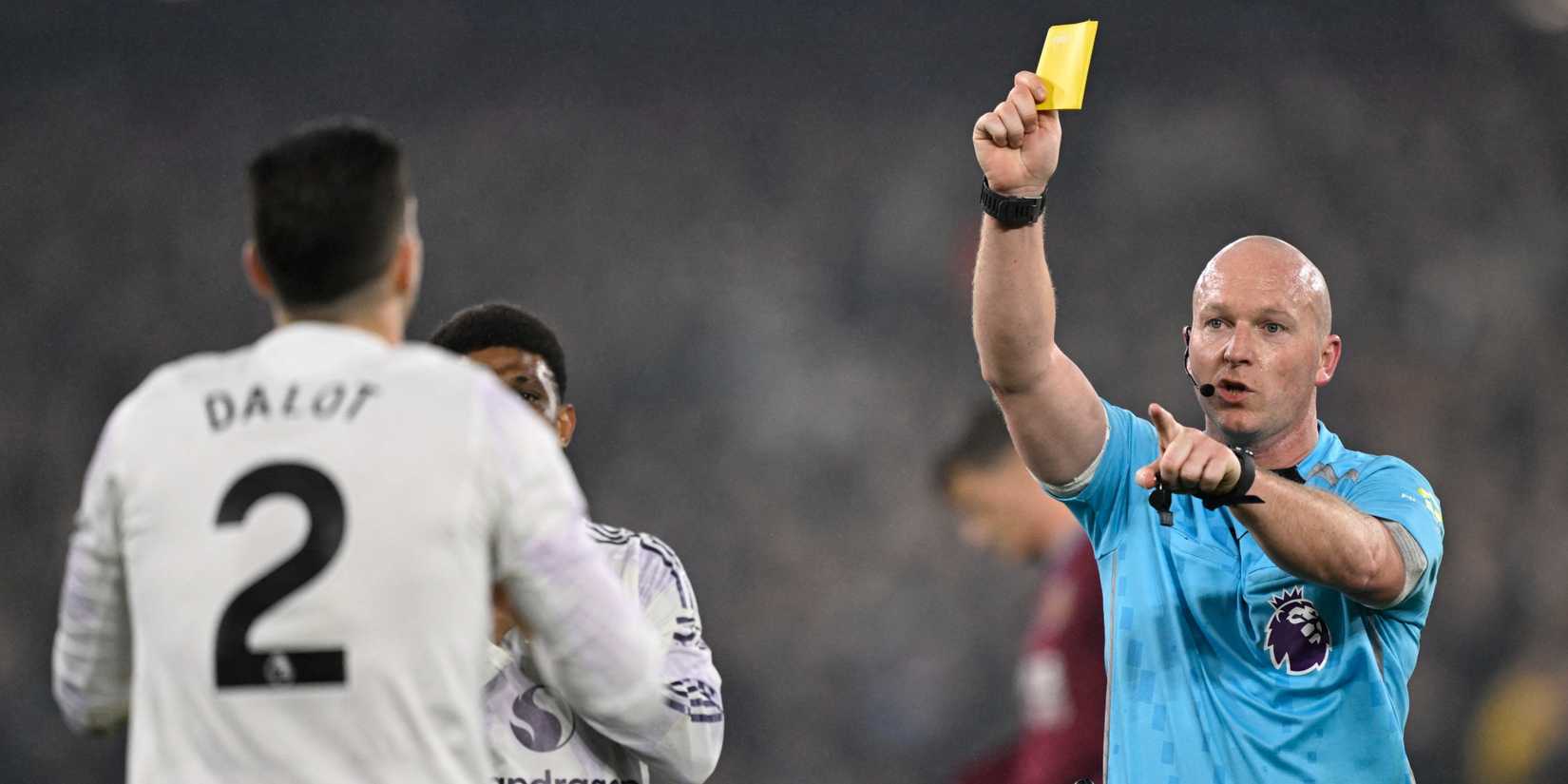 Manchester United's Diogo Dalot is shown a yellow card by referee Simon Hooper vs West Ham