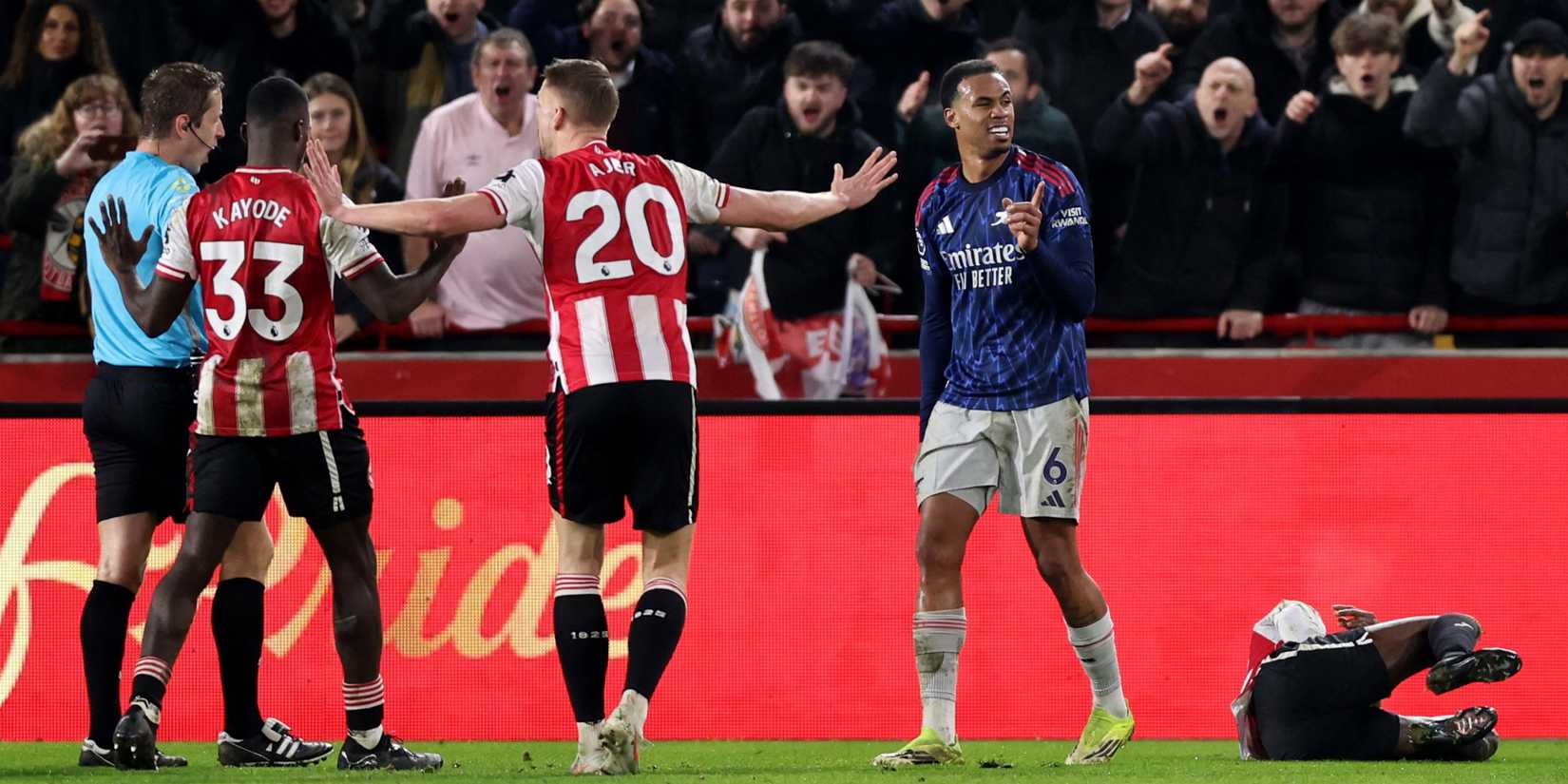 Brentford's Kristoffer Ajer argues with the referee after Arsenal's Gabriel Magalhaes' foul