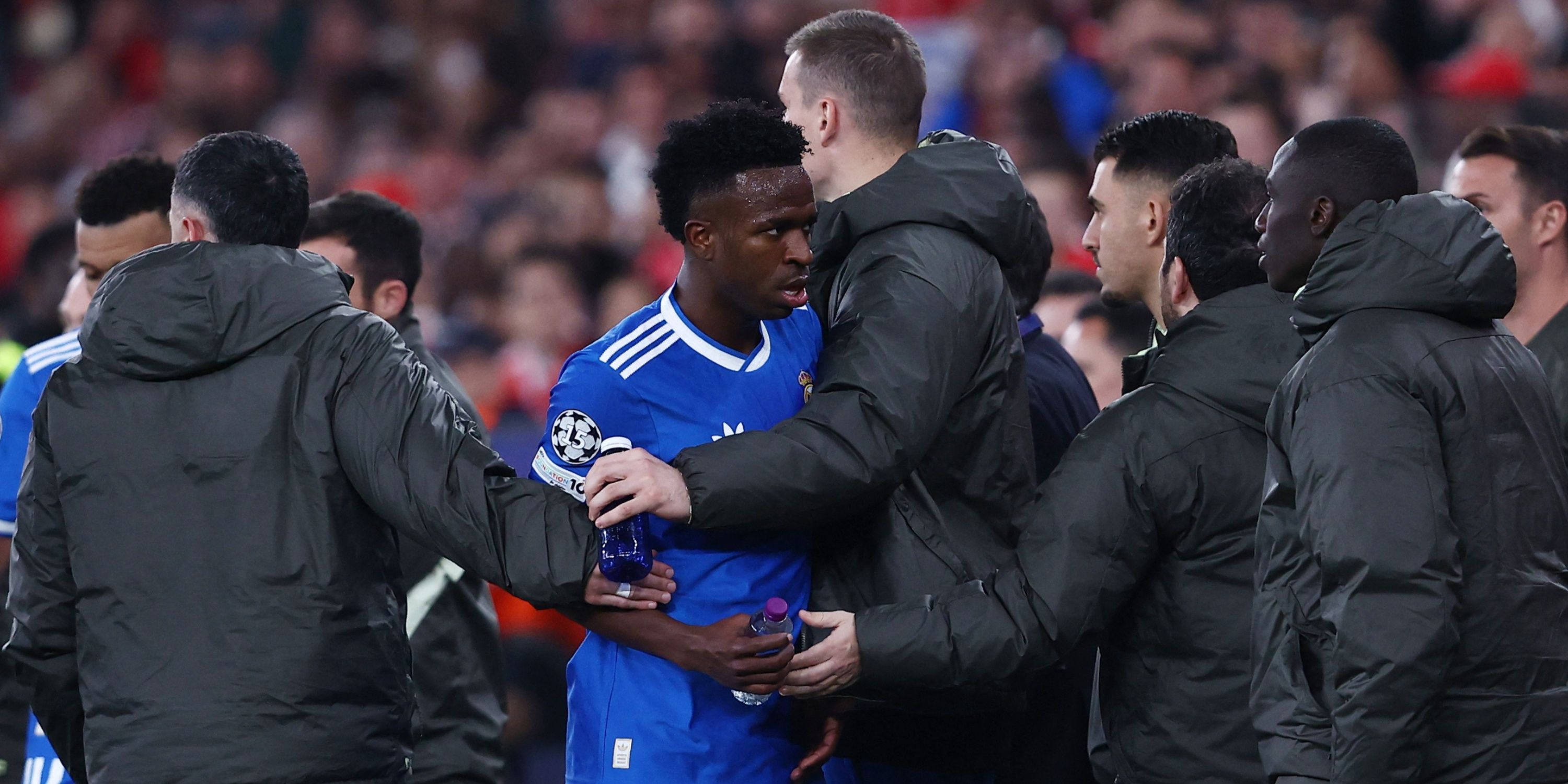 Real Madrid's Vinicius Junior with teammates as the match was stopped due to racist chants