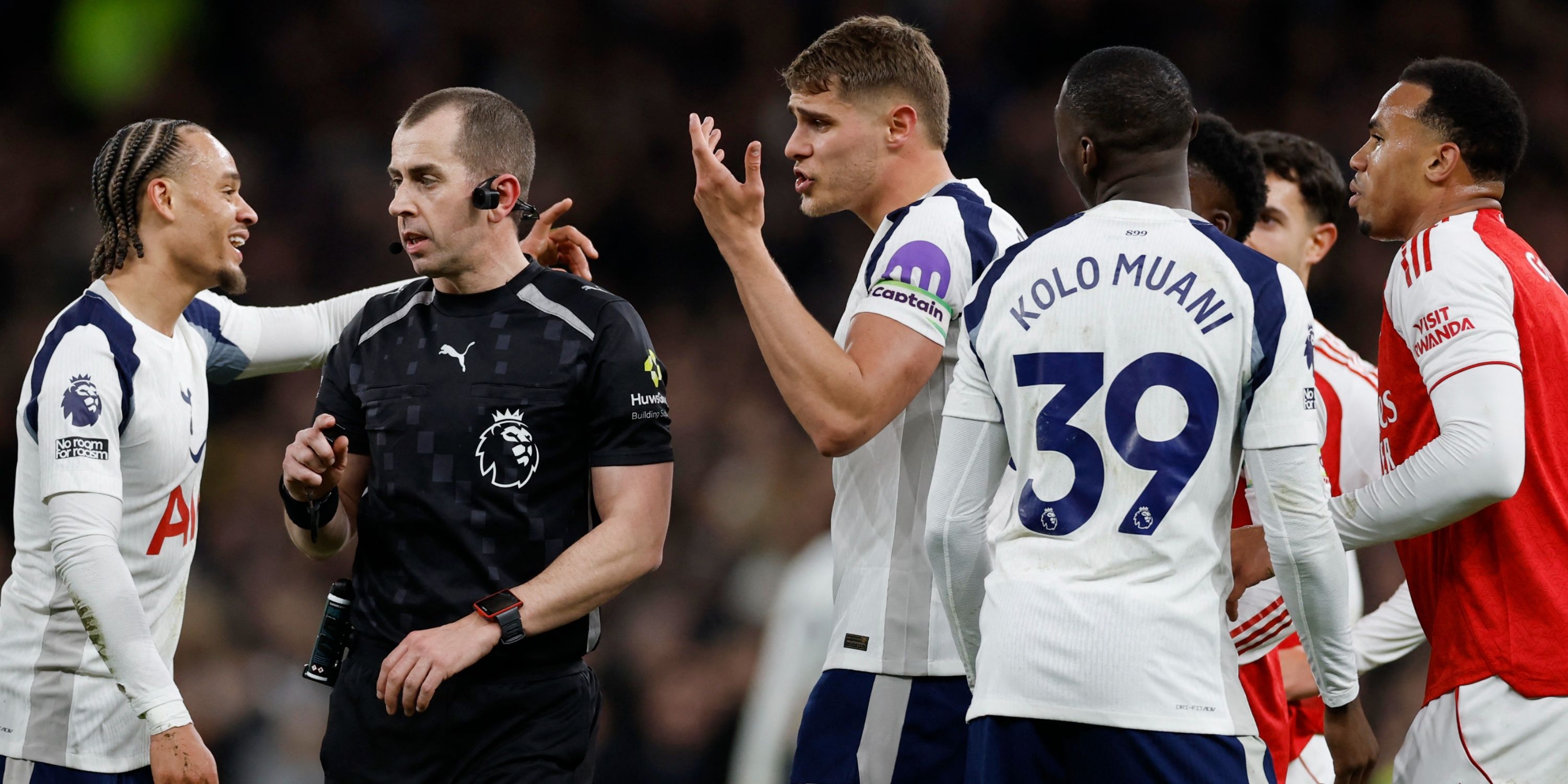 Tottenham and Arsenal players speak to referee Peter Bankes