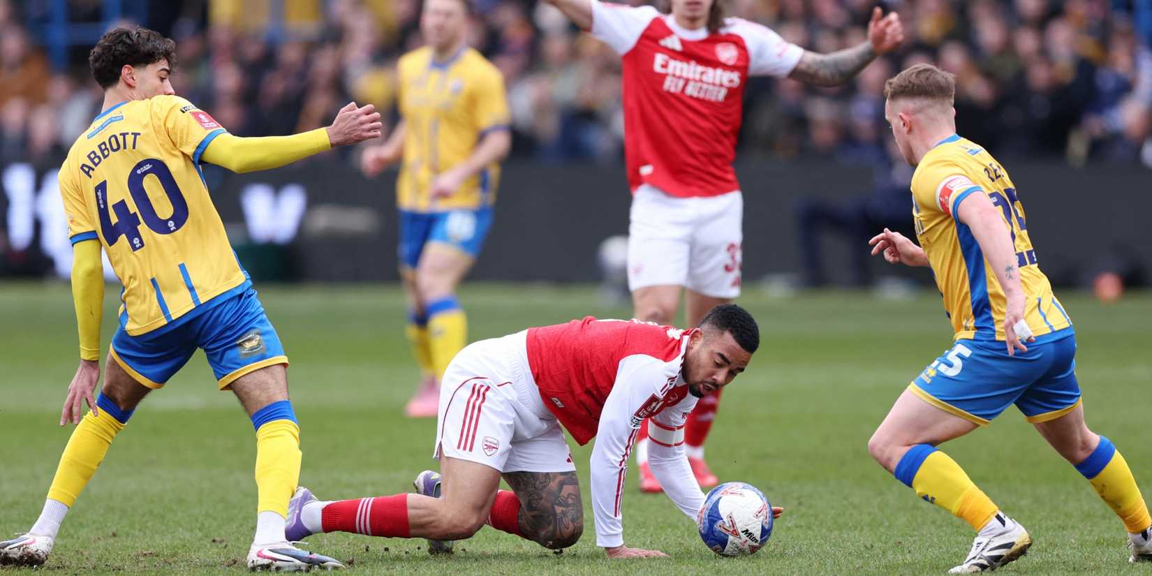 Mansfield Town's George Abbott and Mansfield Town's Louis Reed in action with Arsenal's Gabriel Jesus