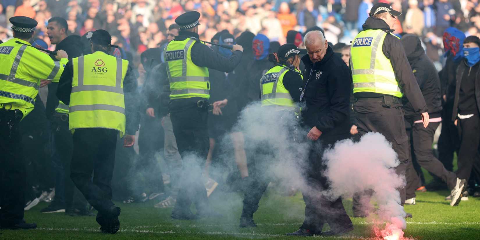 General view of a flare on the pitch as Rangers fans clash with police after the match