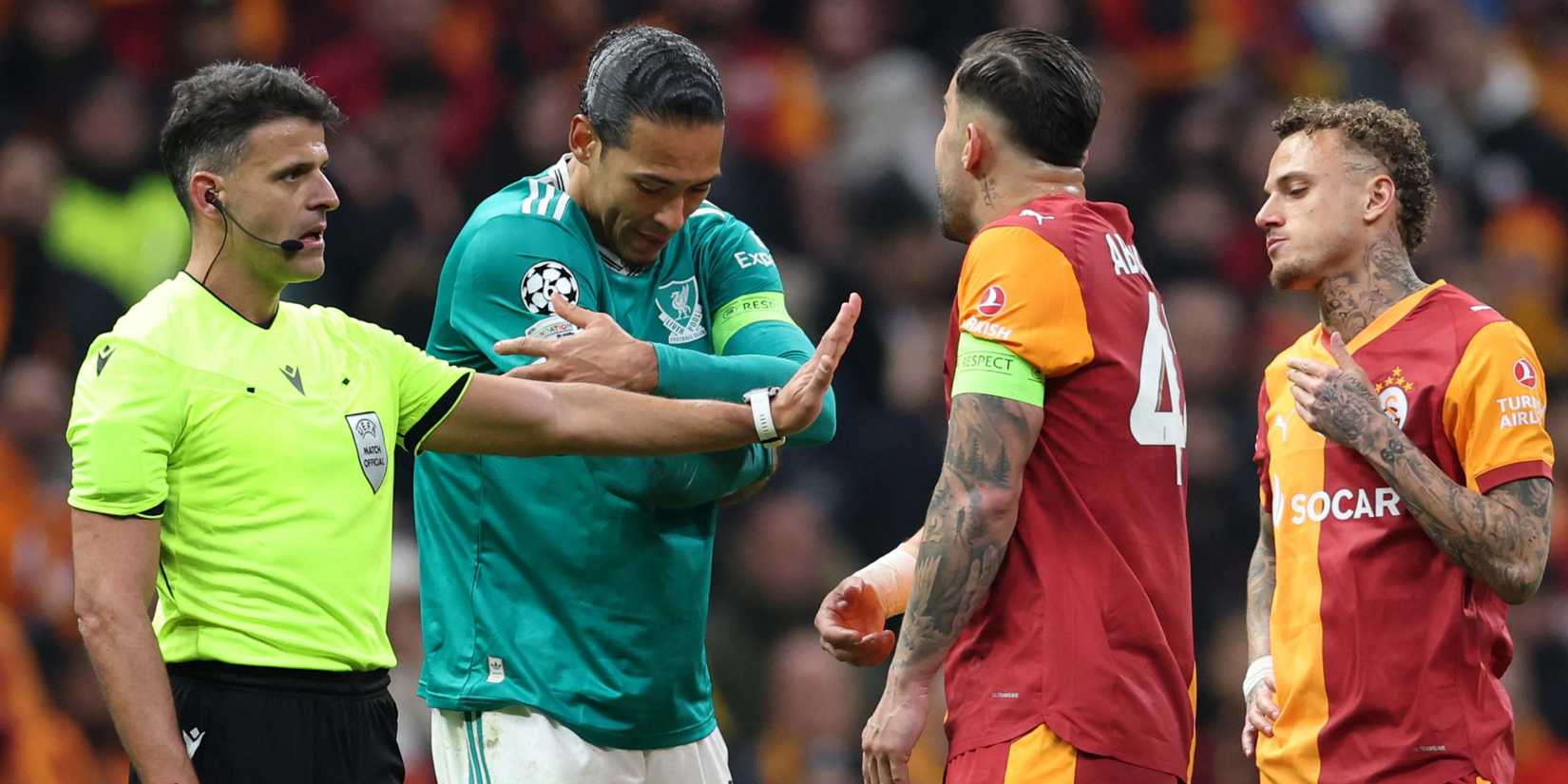 Liverpool and Galatasaray players speak with the referee