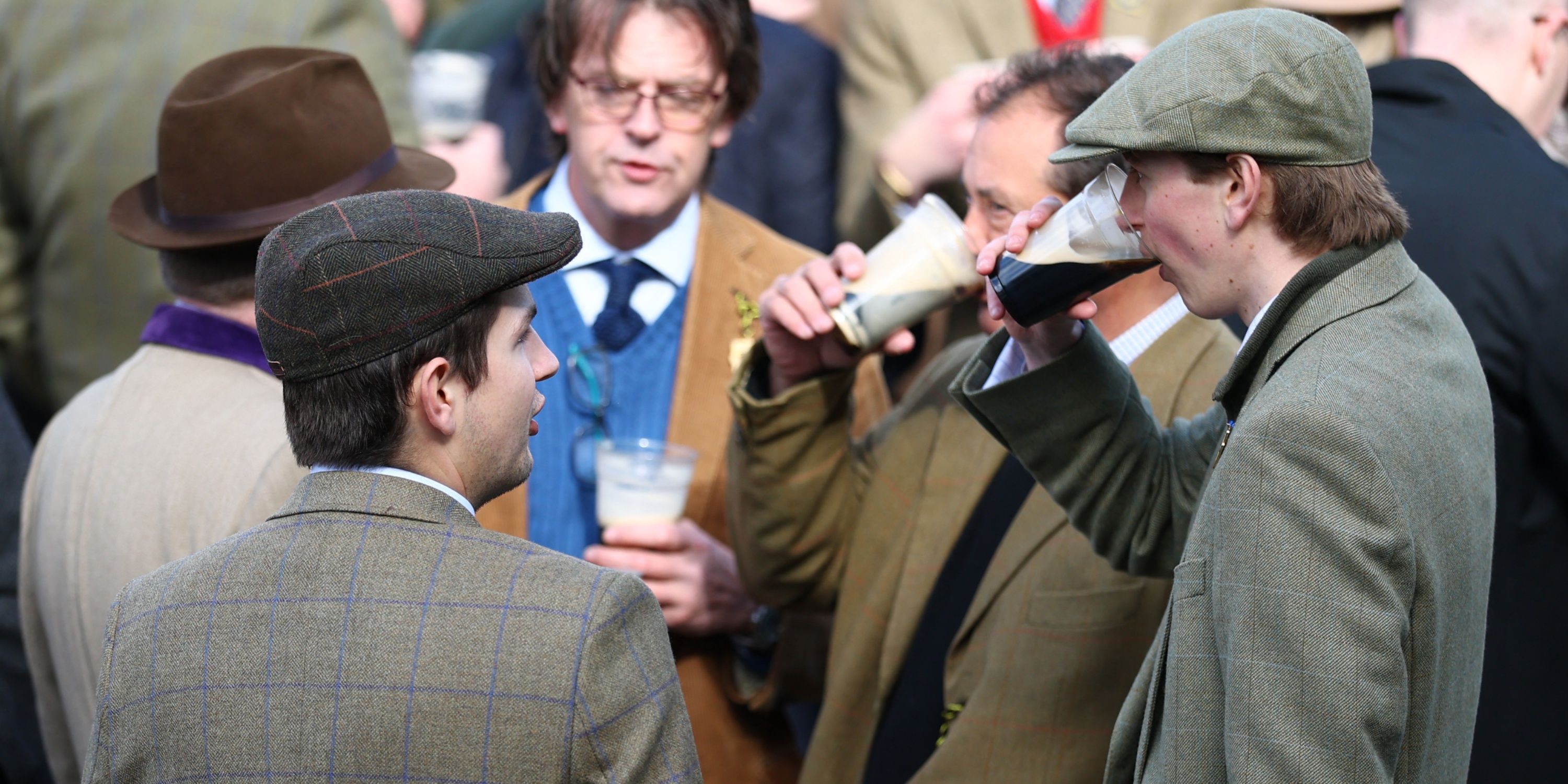 Racegoers drink ahead of the Cheltenham Festival races