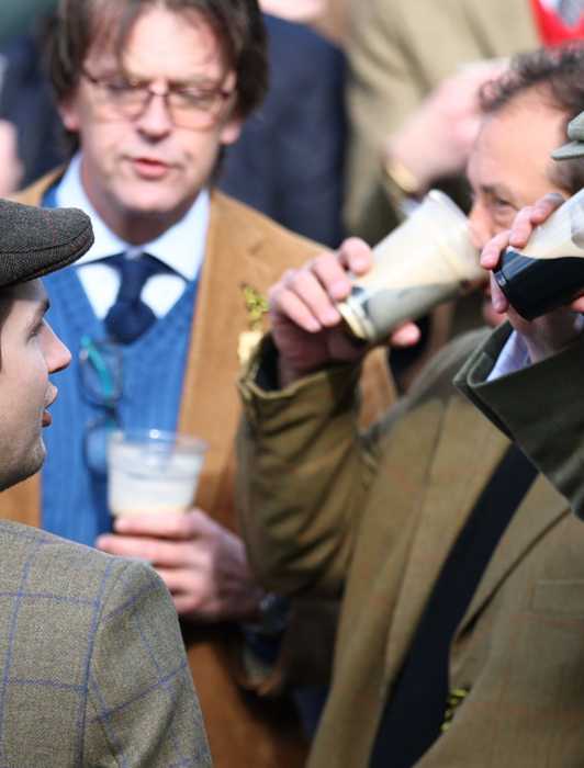 Racegoers drink ahead of the Cheltenham Festival races