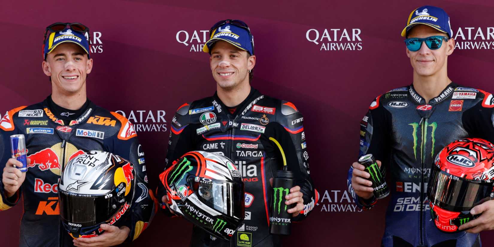 Aprilia Racing's Marco Bezzecchi celebrates after finishing first in qualifying ahead of second place Red Bull KTM Factory Racing's Pedro Acosta and third place Monster Energy Yamaha MotoGP's Fabio Quartararo
