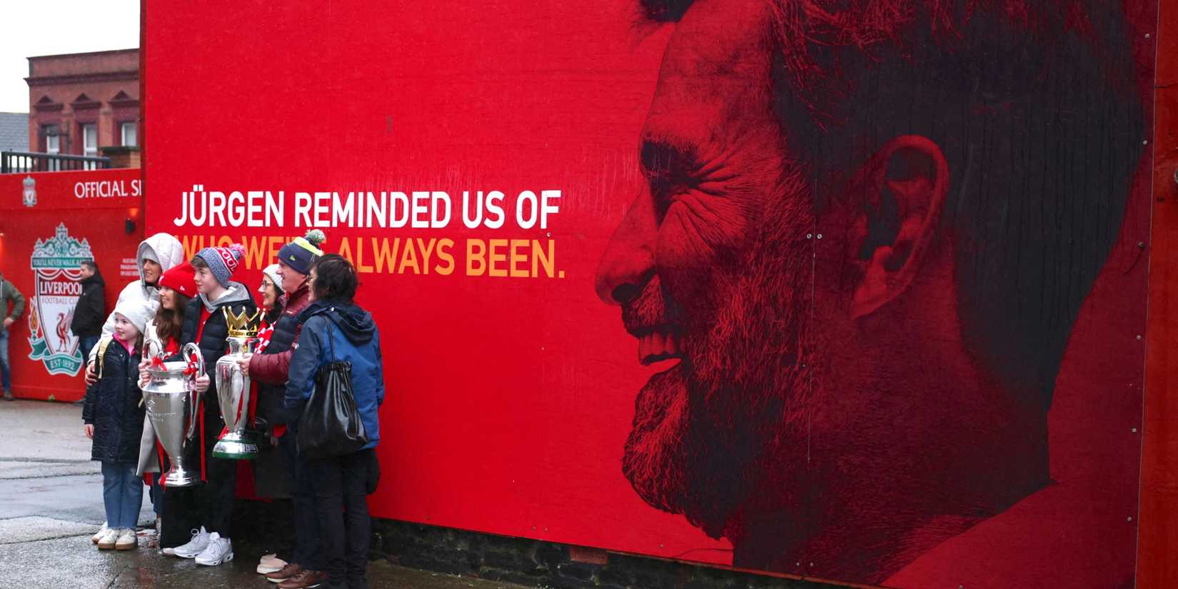 Liverpool fans in front of Jurgen Klopp banner