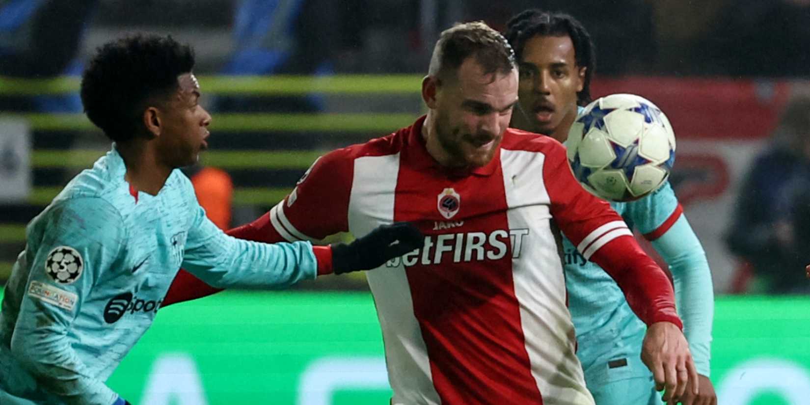Royal Antwerp's Vincent Janssen in action with FC Barcelona's Jules Kounde in 2023