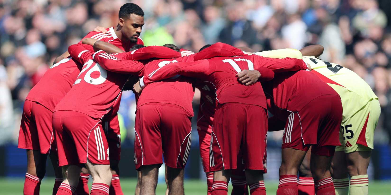 Liverpool players huddle before the match vs Everton