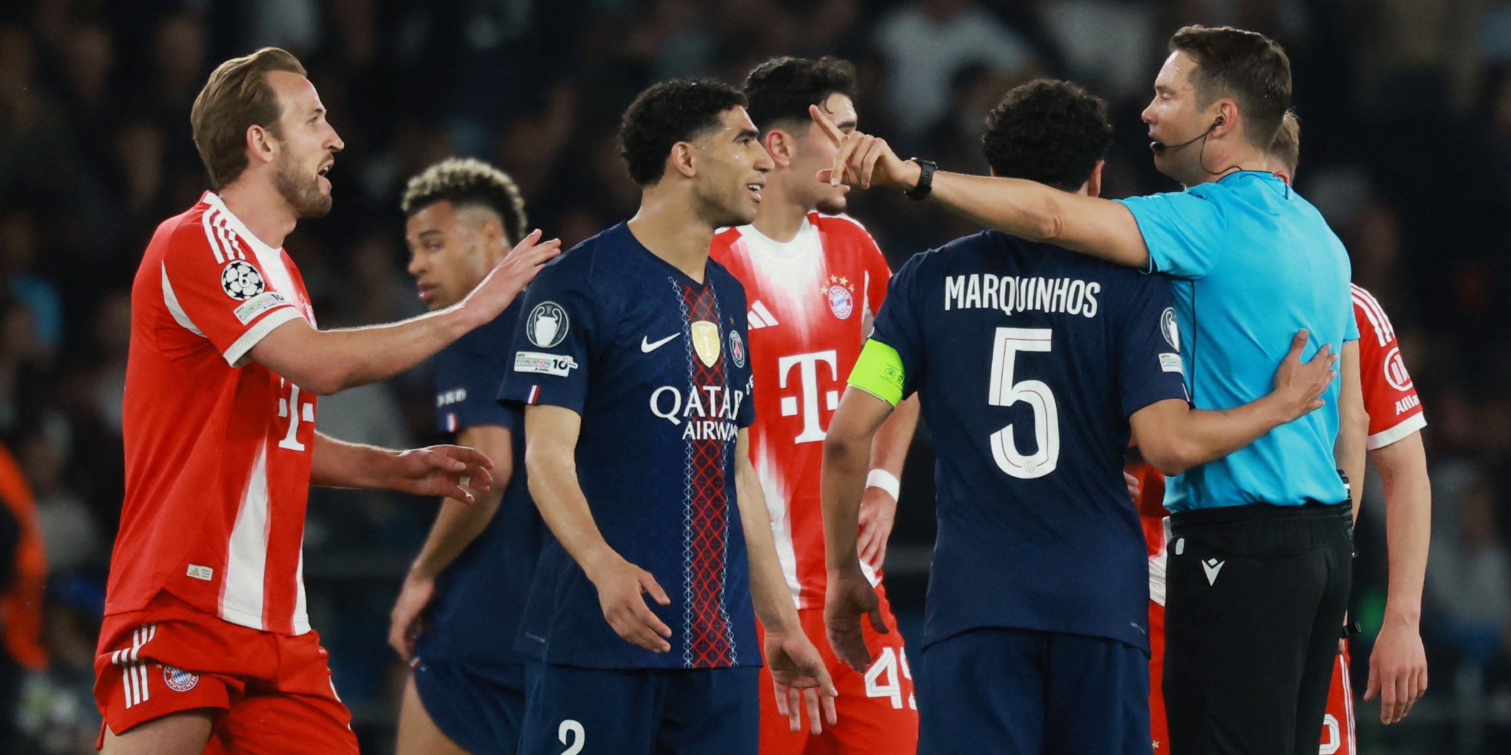Bayern Munich's Harry Kane and teammates talk to referee Sandro Scharer after a penalty is awarded to Paris St Germain