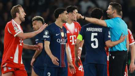 Bayern Munich's Harry Kane and teammates talk to referee Sandro Scharer after a penalty is awarded to Paris St Germain