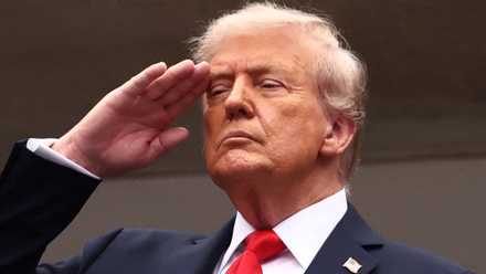 U.S. President Donald Trump is pictured saluting during the national anthem ahead of the final match between Italy's Jannik Sinner and Spain's Carlos Alcaraz
