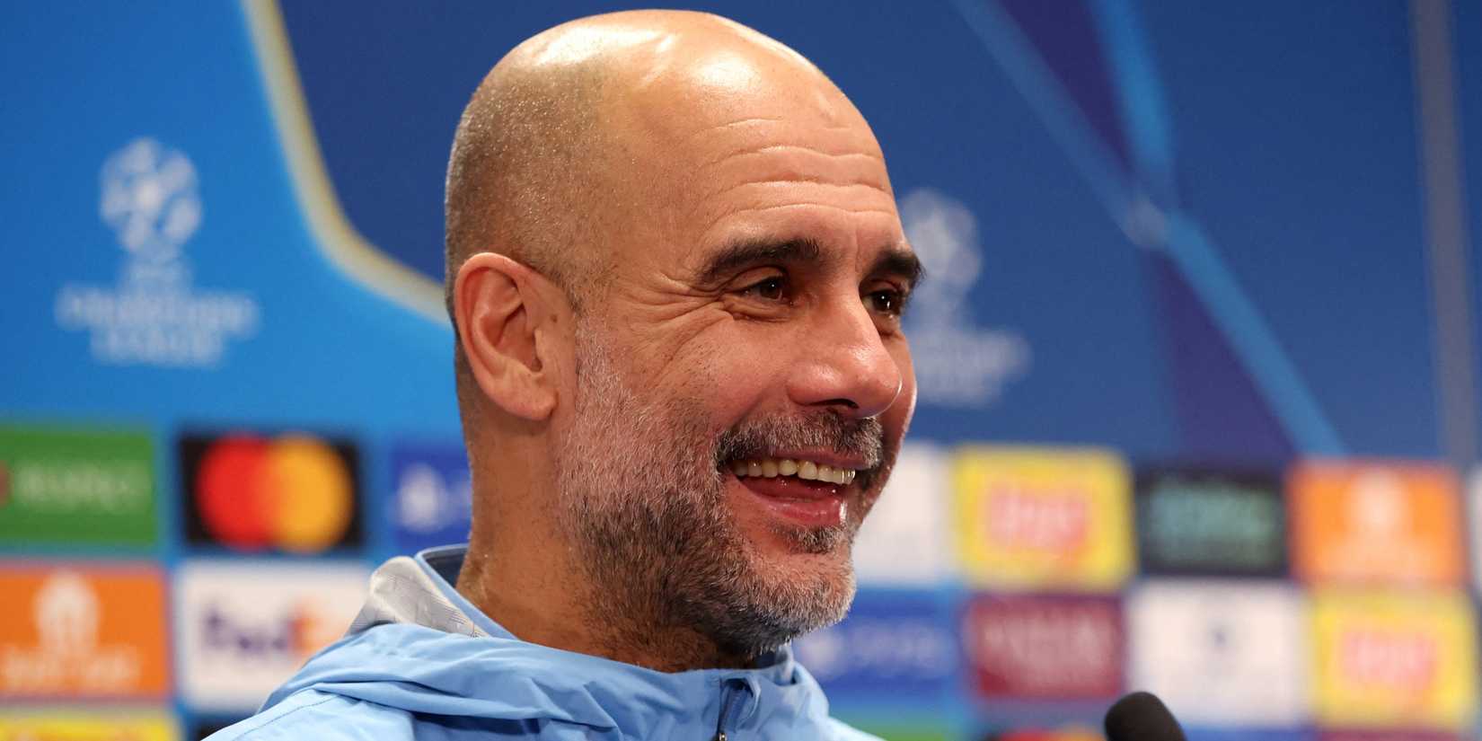 Manchester City manager Pep Guardiola smiles during a press conference in 2026