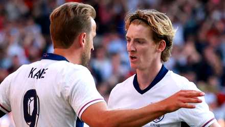 England's Harry Kane celebrates scoring a goal with Anthony Gordon