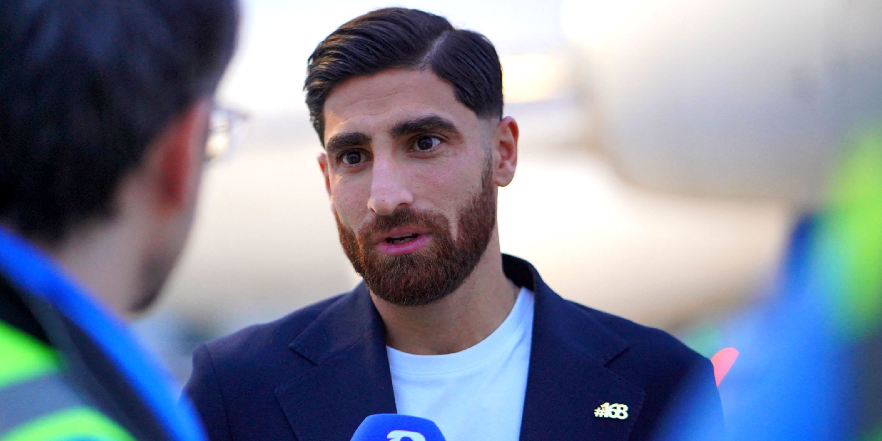 Iran's Alireza Jahanbakhsh speaks to the media, with 168 pin, as he arrives ahead of the World Cup