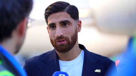Iran's Alireza Jahanbakhsh speaks to the media, with 168 pin, as he arrives ahead of the World Cup