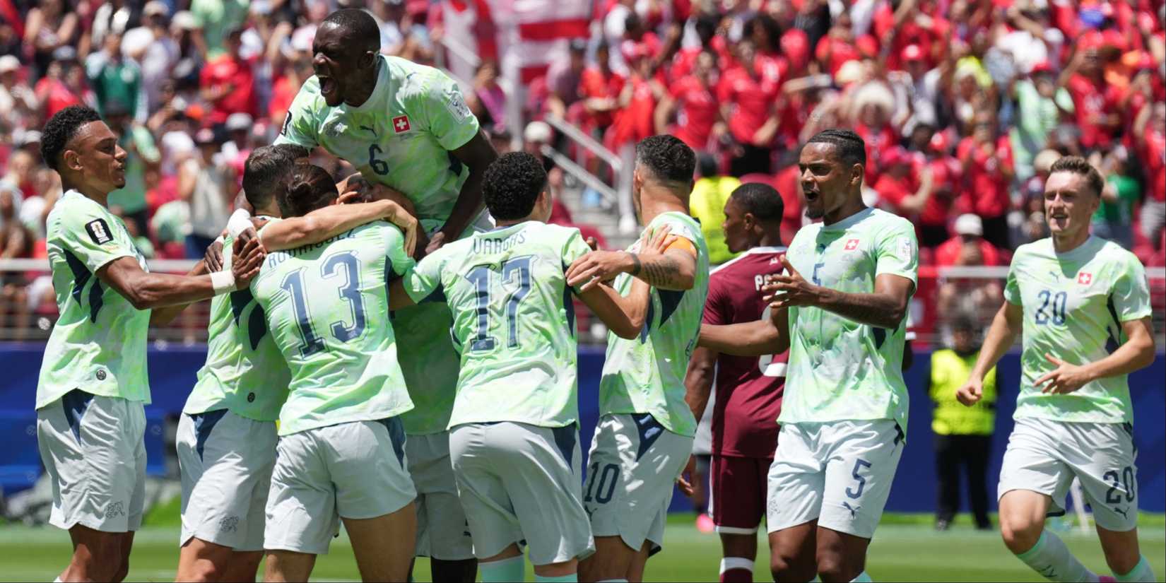 Switzerland players celebrate vs Qatar