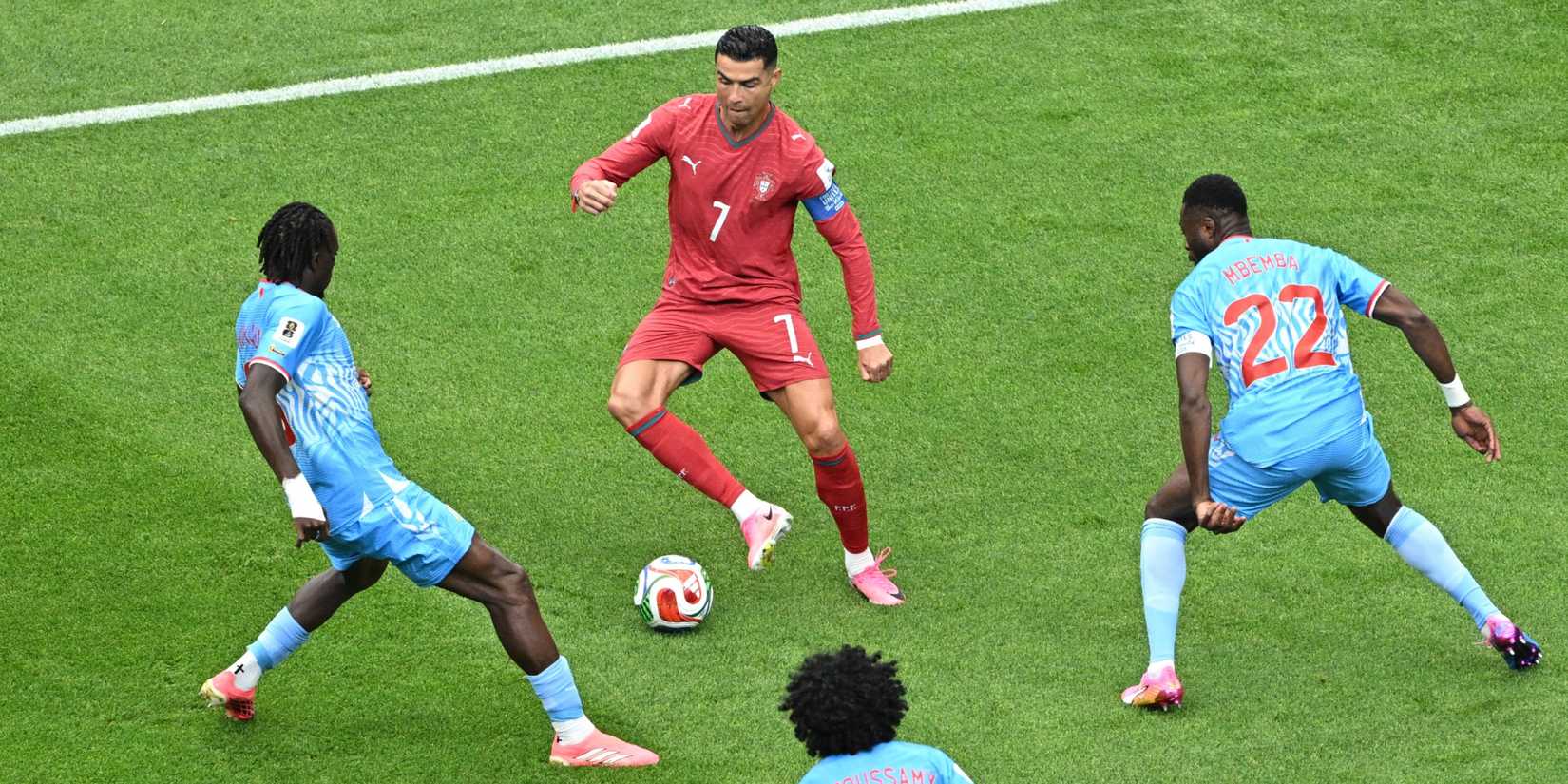 Portugal's Cristiano Ronaldo in action with DR Congo's Ngal'ayel Mukau and Chancel Mbemba