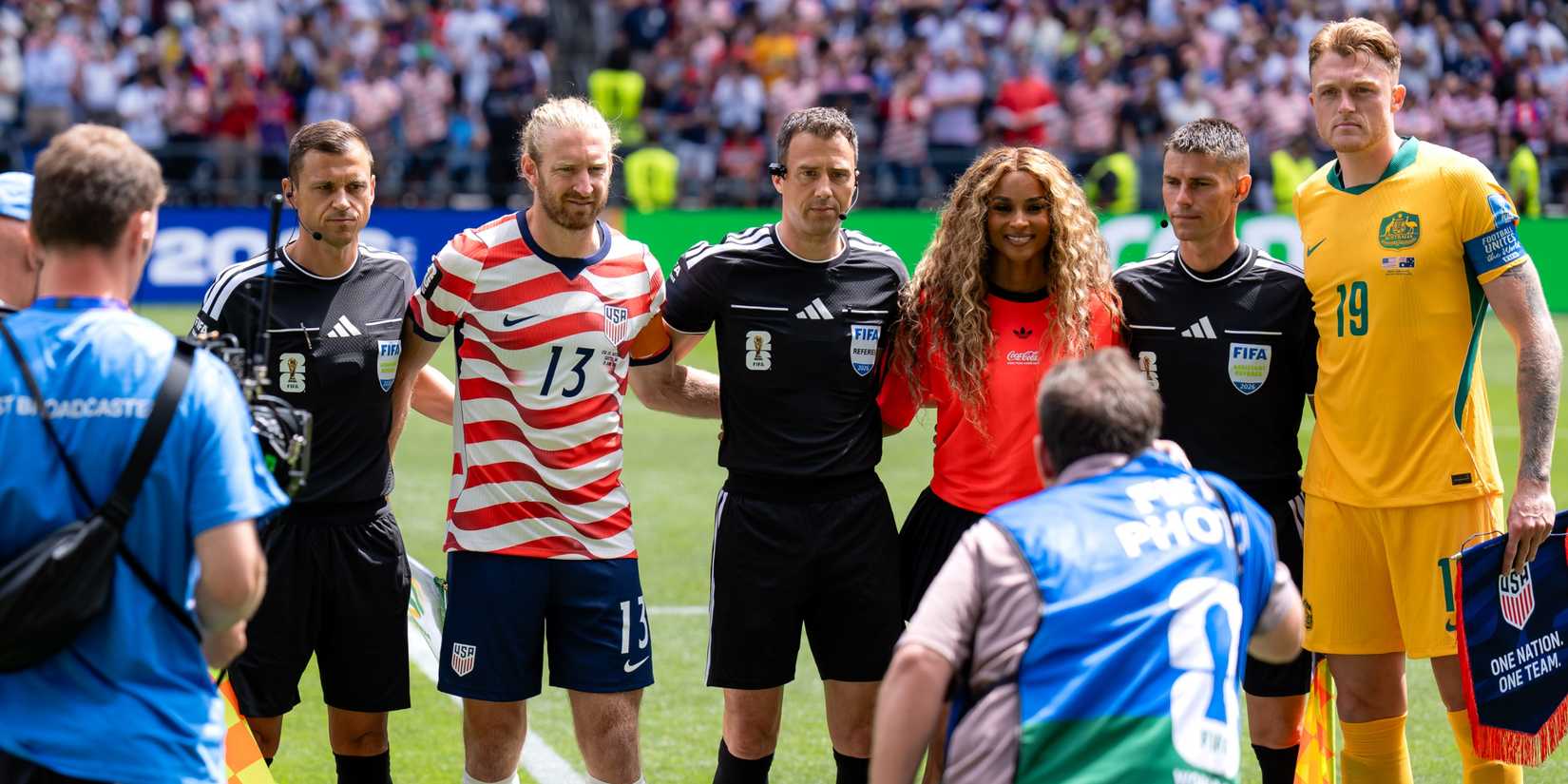 Ciara poses before the match with match officials and captains before USA v Australia.
