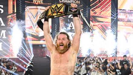 Sami Zayn celebrates with WWE Championship