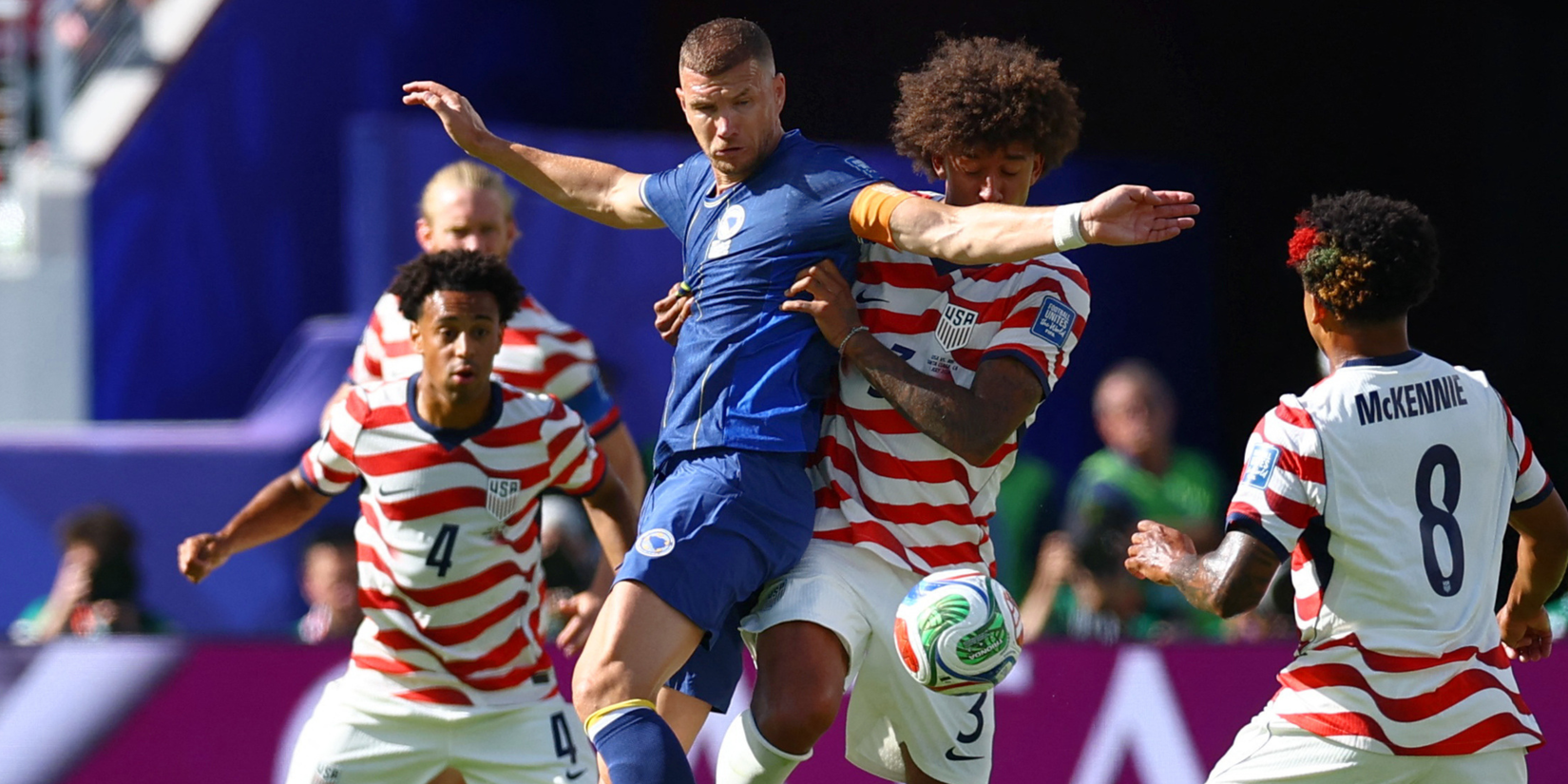 Edin Dzeko (Bosnia) battles Chris Richards (USA)