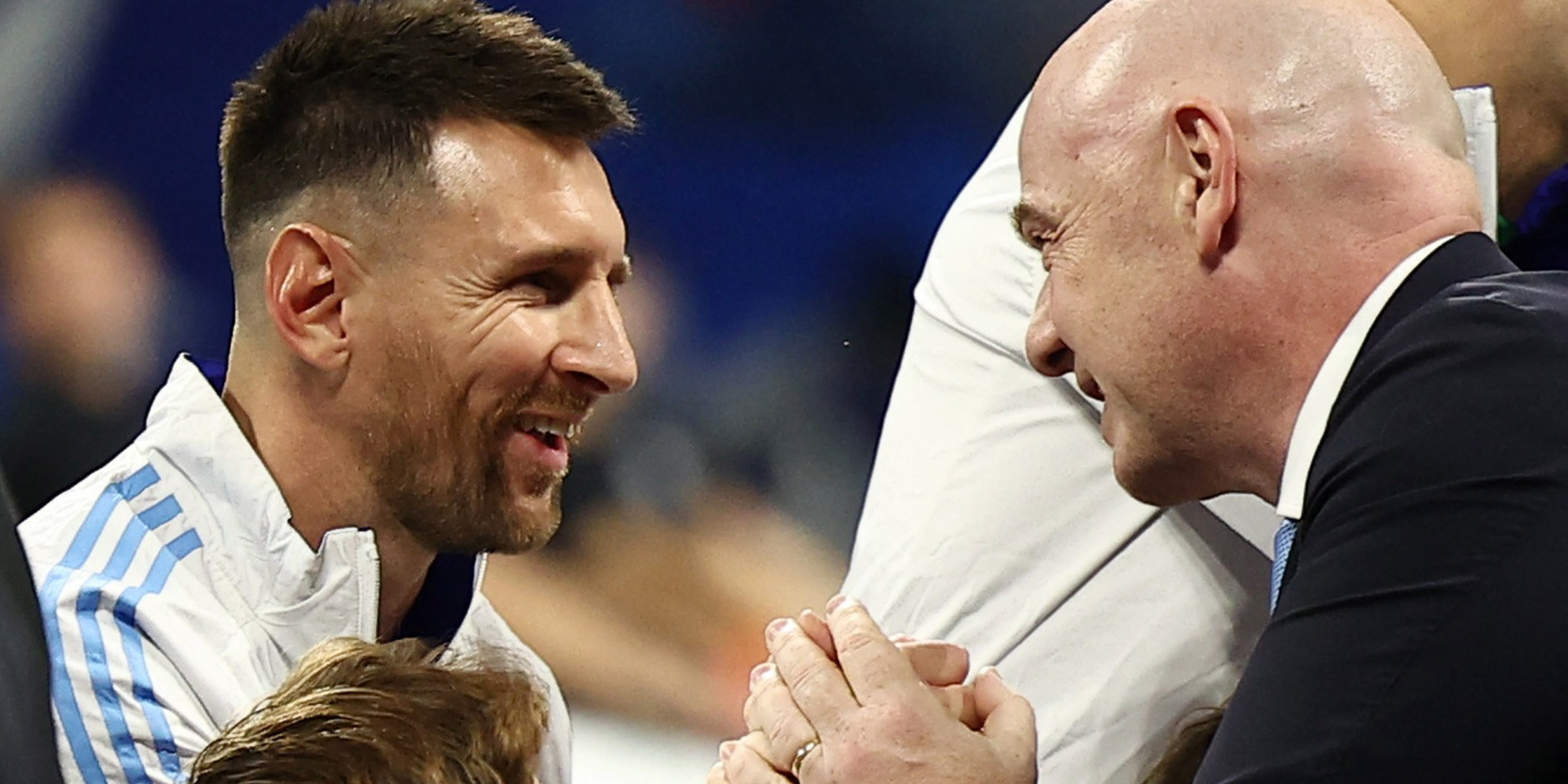FIFA President Gianni Infantino shakes hands with Argentina's Lionel Messi before the match