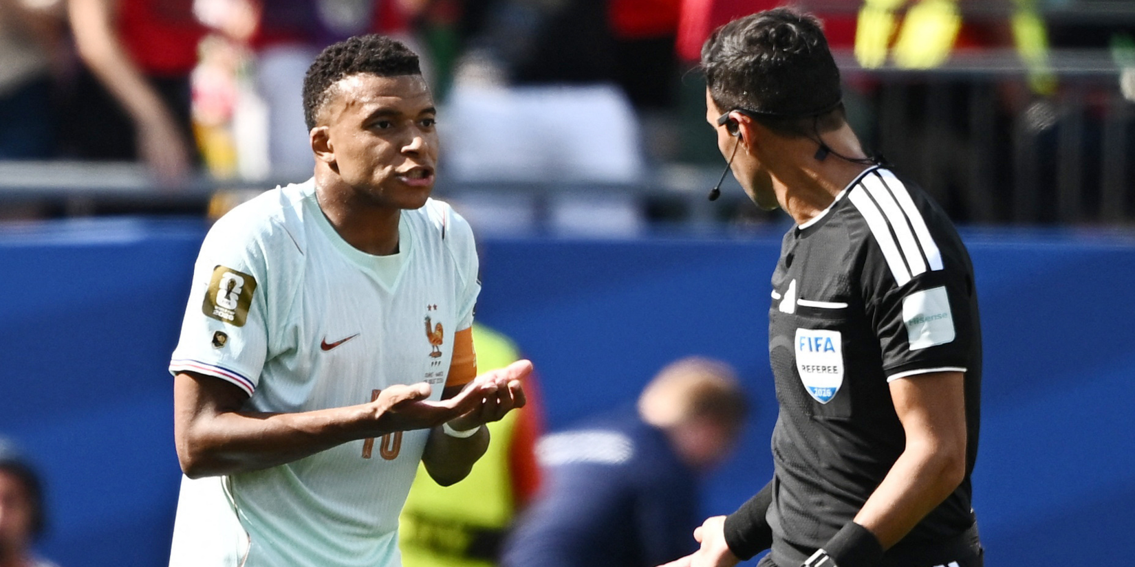 France's Kylian Mbappe remonstrates to referee Facundo Tello 