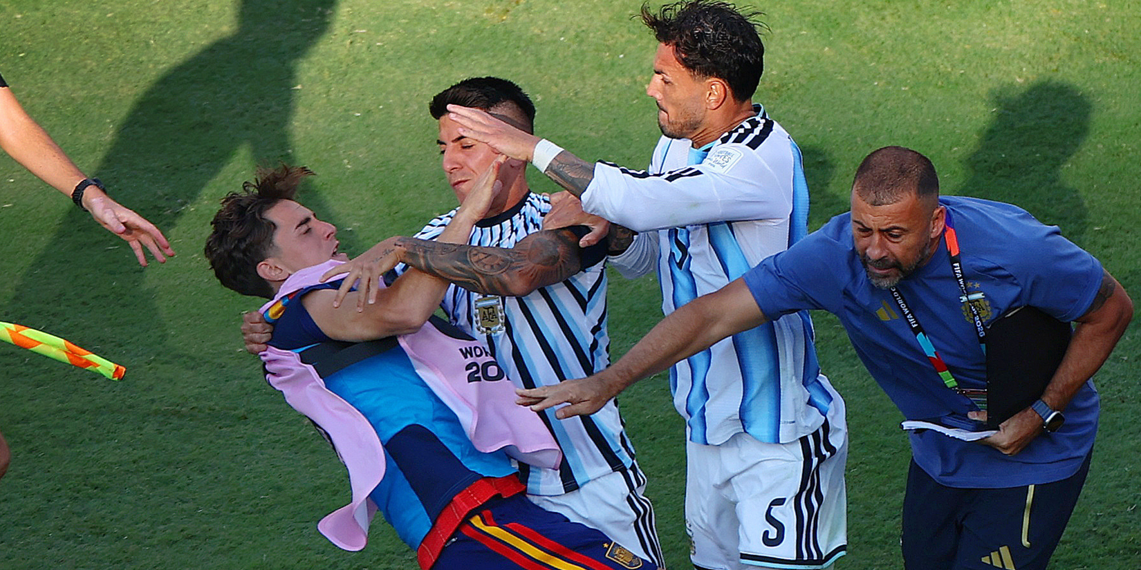 Argentina's Leandro Paredes and Thiago Almada clash with Spain's Gavi after the match