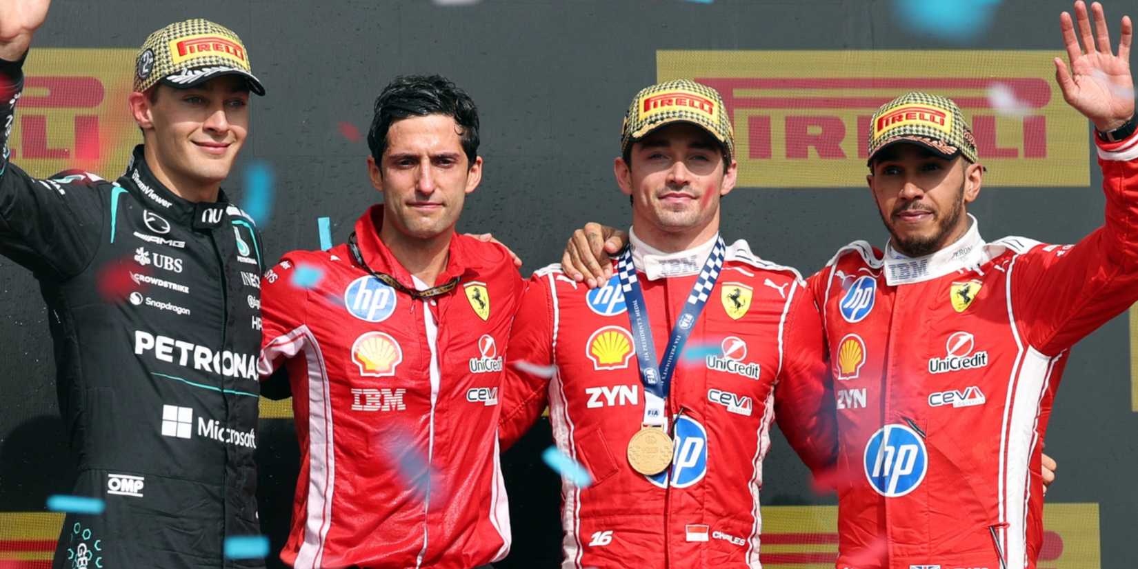 Ferrari's Charles Leclerc celebrates on the podium after winning the British Grand Prix with Mercedes' George Russell who finished second and Ferrari's Lewis Hamilton who finished third