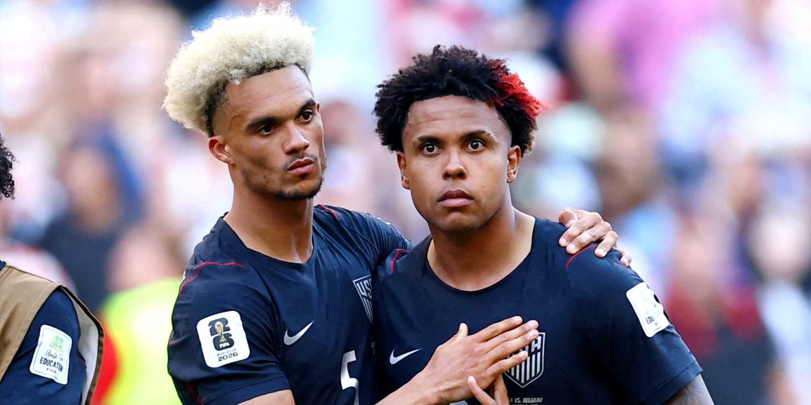 Antonee Robinson and Weston McKennie of the U.S. look dejected after the match as the United States are eliminated from the World Cup by Belgium