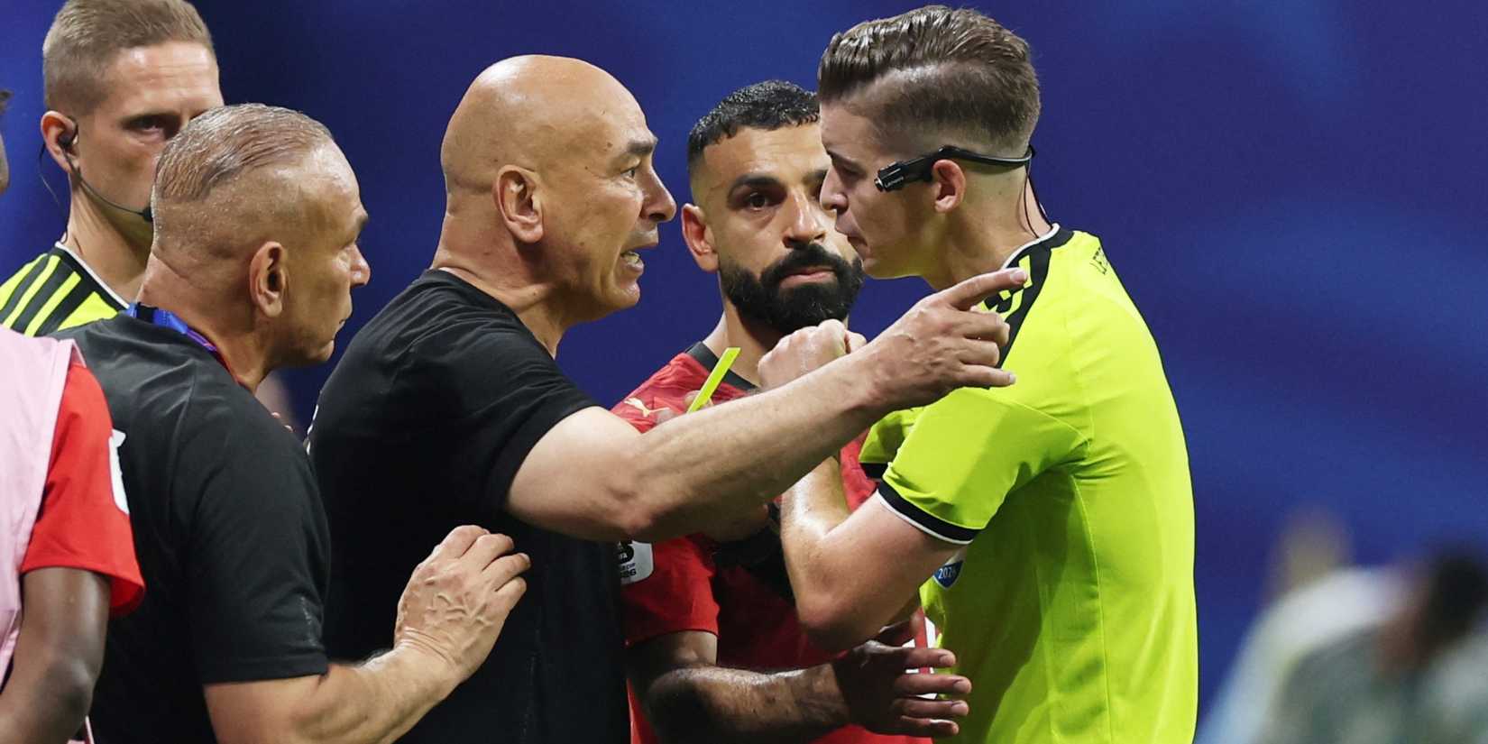 Egypt coaches argue with the referee after Argentina's winner
