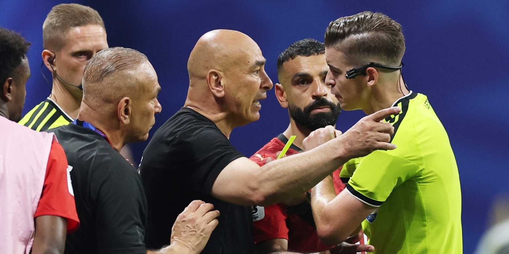 Egypt coach Hossam Hassan is shown a yellow card by referee Francois Letexier