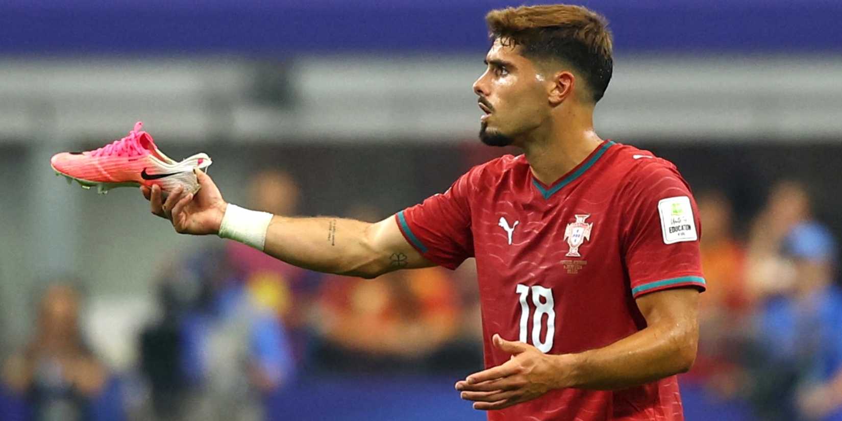 Portugal's Pedro Neto reacts as his boot comes off