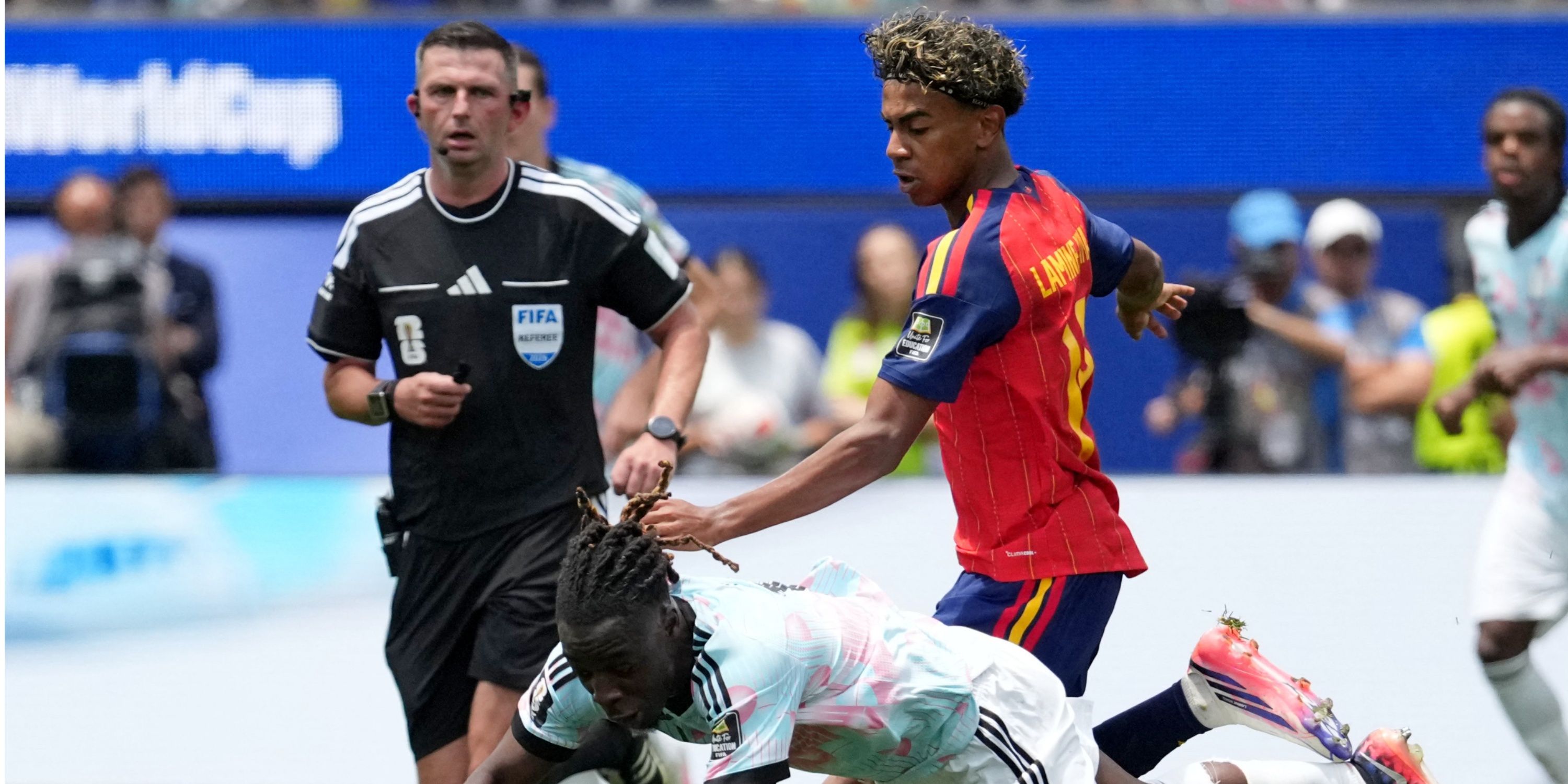 Belgium's Jeremy Doku in action with Spain's Lamine Yamal