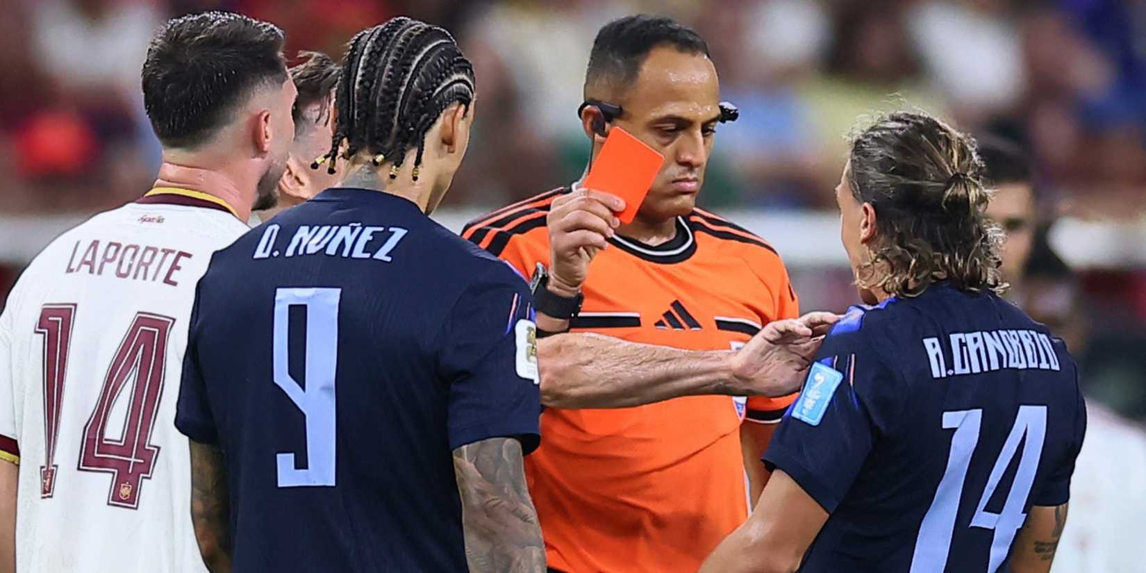 Uruguay's Agustin Canobbio is shown a red card by referee