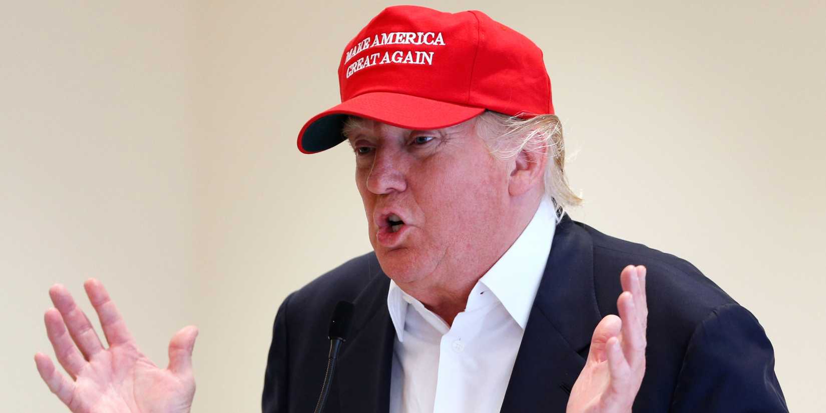 US President Donald Trump talks at a press conference wearing a MAGA hat