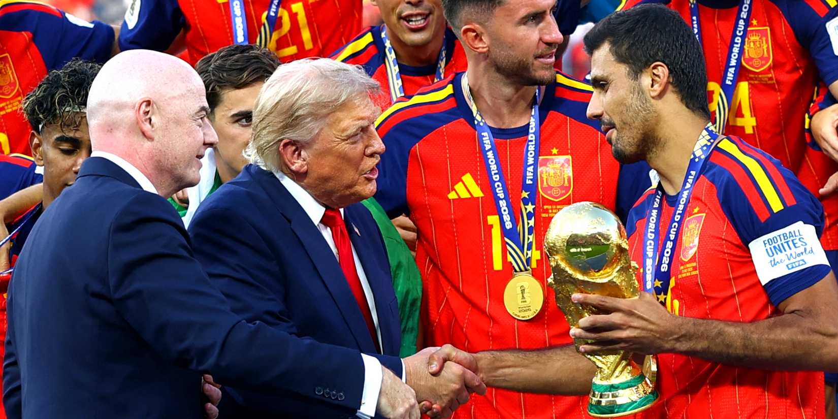 U.S. President Donald Trump and FIFA president Gianni Infantino hand the World Cup trophy to Spain's Rod