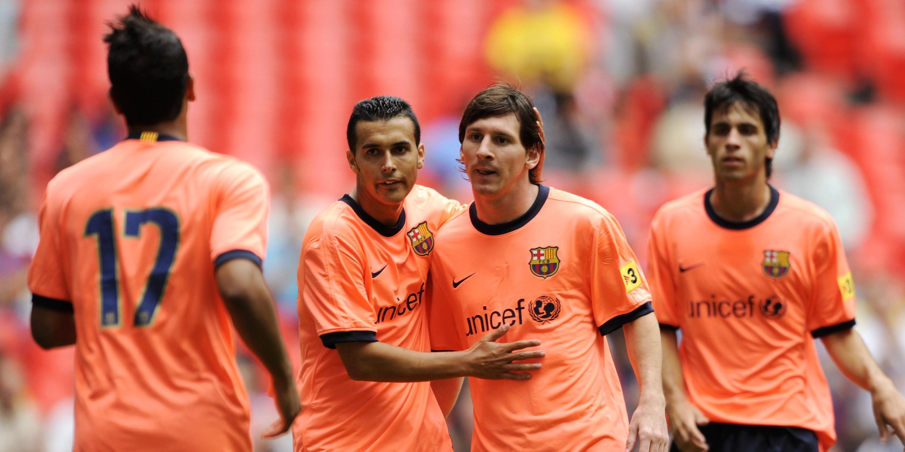 Jeffren Suarez celebrates scoring the third goal for Barcelona with Lionel Messi and Pedro